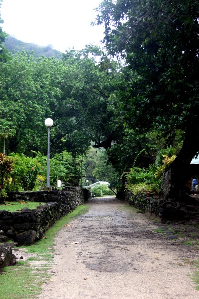 Road through town lined with high rock walls from long ago.